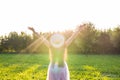 Free happy young woman raising arms watching the sun in the background at sunrise Royalty Free Stock Photo