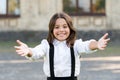 Free hugs. Come here. Schoolgirl pull hands to you. Smiling schoolgirl sincere child glad to see you. Welcome back to Royalty Free Stock Photo