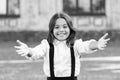 Free hugs. Come here. Schoolgirl pull hands to you. Smiling schoolgirl sincere child glad to see you. Welcome back to Royalty Free Stock Photo