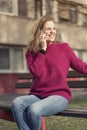 Free joyful woman using her cell phone in a park on a sunny day Royalty Free Stock Photo