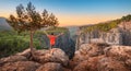 Man with open arms stands on top of a cliff above the gorge of Tazi canyon in Turkey. Solitude in nature and active solo