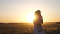 Free mom and little daughter are dancing in sunset. Mother and healthy baby in her arms in field. concept of a happy Royalty Free Stock Photo