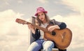 free music content. Teenage musician playing guitar. Portrait of little kid playing guitar on sky background. summer Royalty Free Stock Photo