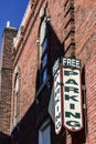 Free Parking Sign Hanging on an old Brick Building