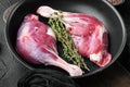 Free Range Farm Duck Legs, on frying cast iron pan, on black stone background Royalty Free Stock Photo