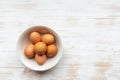 Free-range organic brown eggs in bowl on wooden background Royalty Free Stock Photo