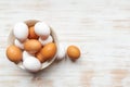 Free-range organic brown and white eggs in bowl and two eggs near on wood background Royalty Free Stock Photo