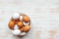 Free-range organic white and brown eggs in bowl on wood background with copy space Royalty Free Stock Photo