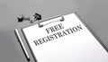 FREE REGISTRATION text on white paper sheet on black background