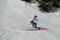 Free rider seen from side angle, wearing short sleeve t-shirt and making a turn in Stowe Mountain resort in Vermont