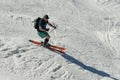 Free rider seen from side angle, wearing swim shorts and making a turn in Stowe Mountain resort in Vermont