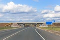 Viaduct on the highway,road signs, autumn fields and trees along the side of the road.The concept of choosing your life path,