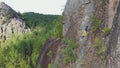 Free solo climbing on a rock wall in the Siberian nature Reserve Stolby.