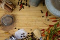 Free space for text on wooden background of cutting board with wooden texture and scattered spices on it. Top view on void wooden