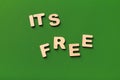 It is free spelled with wooden letters on green background