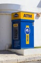 A free standing cash machine on a street pavement outside a grocery store in Albuferia in Portugal