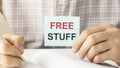 Free stuff  message on white card and hold Royalty Free Stock Photo