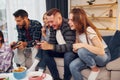 Free time entertainment. Group of friends have party indoors together Royalty Free Stock Photo