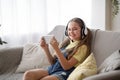 Girl wearing headset enjoying music with phone Royalty Free Stock Photo