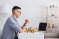 Free time, leisure and hobbies. Man teaching play chess remotely