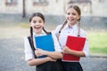 Free time at school break. teen pupils ready for lesson. prepare to exam. study together outdoor. small girls with books Royalty Free Stock Photo
