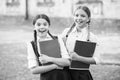 free time at school break. teen pupils ready for lesson. prepare to exam. study together outdoor. small girls with books Royalty Free Stock Photo