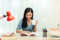 Free Time. Young woman in glasses reading book sitting at home, drinking tea Royalty Free Stock Photo