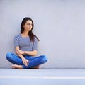 Free to be myself. Full length shot of a beautiful young woman sitting on the floor. Royalty Free Stock Photo