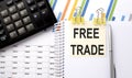 FREE TRADE text, written on a sticker with calculator,pen on the chart background Royalty Free Stock Photo