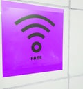 Free Wi-Fi zone symbol, purple sign on a white wall in a public empty space