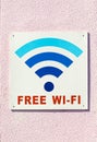 Free wifi sign on light wall outdoors Royalty Free Stock Photo