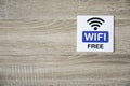 Free WiFi sign on wooden wall with space for adding text on the left side Royalty Free Stock Photo