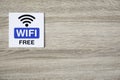 Free WiFi sign on wooden wall with space for adding text on the right side Royalty Free Stock Photo