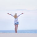 Free woman enjoying freedom on beach in morning. Royalty Free Stock Photo