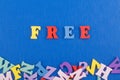 FREE word on blue background composed from colorful abc alphabet block wooden letters, copy space for ad text. Learning english Royalty Free Stock Photo