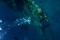Freediver man make bubbles at underwater shipwreck Royalty Free Stock Photo