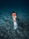 Freediver woman dive underwater with white fins. Summer freediving with attractive woman in sea