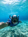 Freediver young man taking selfie portrait underwater