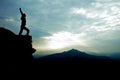 Man on top of cliff with arms raised Royalty Free Stock Photo