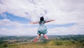 Freedom active child girl jumping at the top of mountain