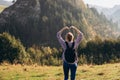 Freedom and active lifestyle concept. Adventure women making by hands in shape of love heart. Back view of Woman in Royalty Free Stock Photo