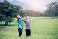 Freedom African man and asian man travelers standing in the green nature background.Concept of best friends