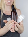 Girl holds in her hands three eco-friendly antiperspirants with natural ingredients. Refusal of antiperspirants containing toxic Royalty Free Stock Photo