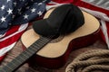 Freedom and american country and blues music festival concept with USA flag and acoustic guitar with a black cap on top and cowboy