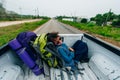 freedom backpacker girl with big backpack and travel hitchhiking growth in the back of a pickup truck