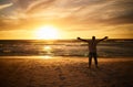 Freedom, beach and man silhouette celebration at sunset, happy and success in nature. Motivation, health, and energy Royalty Free Stock Photo