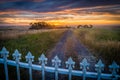 Freedom beyond the fence, sunset over a fence and trail