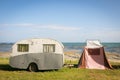 Freedom camping in vintage caravan and tent at an East Coast beach, Gisborne, North Island, New Zealand