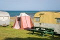 Freedom camping in vintage caravans and tent at an East Coast beach, Gisborne, North Island, New Zealand