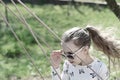 Freedom, carefree lifestyle and fun. Fashion girl in sunglasses enjoy swinging on sunny day. Little child on swing in Royalty Free Stock Photo